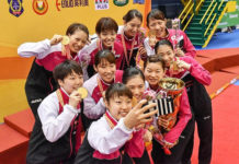 Japan's gold medal-winning BATC women's team take a selfie during the medal ceremony. (photo: AP)