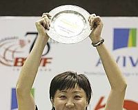 Worthy winner: Hong Kong&rsquo;s Zhou Mi holding the trophy after winning the women&rsquo;s singles final Sunday.