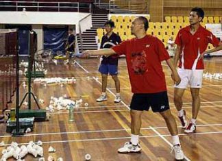Hands-on coach: Hendrawan teaching Mohd Hafiz Hashim (right) how to return a net shot during training yesterday.