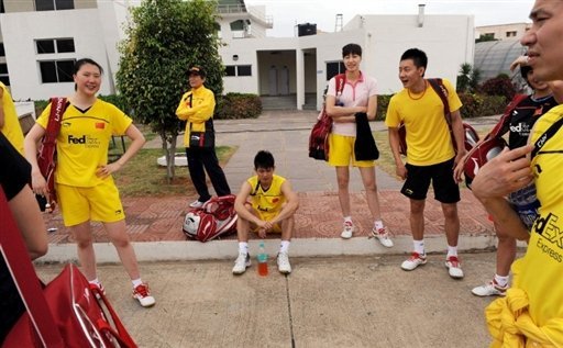 Chinese badminton players wait for transport after a training session at Hyderabad's Gachibowli Stadium