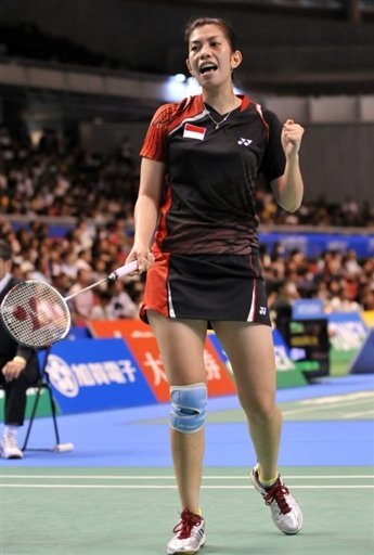 Adriyanti Firdasari of Indonesia reacts after winning a point against Zhou Mi of Hong Kong
