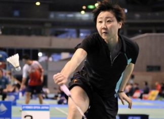 Zhou Mi of Hong Kong reaches for a return against Adriyanti Firdasari of Indonesia