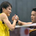 Bao Chunlai of China (L) and Taufik Hidayat of Indonesia shake hands after their men’s singles final match in the Japan