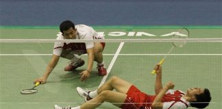 South Korean Lee Yong- dae, bottom, reacts after scoring a point as his teammate Jung Dung-jae looks on during men's doubles final match against Chinese Cai Yun and Fu Haifeng during the Korea Open Badminton Super Series in Seoul, South Korea, Sunday, Jan. 17, 2010. South Korea won the match 21-11, 14-21 and 21-18.