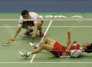 South Korean Lee Yong- dae, bottom, reacts after scoring a point as his teammate Jung Dung-jae looks on during men's doubles final match against Chinese Cai Yun and Fu Haifeng during the Korea Open Badminton Super Series in Seoul, South Korea, Sunday, Jan. 17, 2010. South Korea won the match 21-11, 14-21 and 21-18.