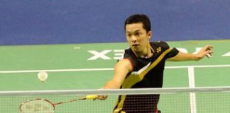Taufik Hidayat returns a shot to Hu Yun