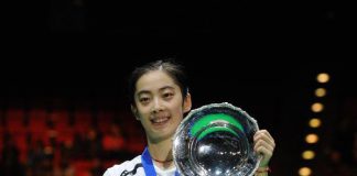 China's Wang Shixian poses with her trophy after winning the women's singles final match against Japan's Eriko Hirose in 2011's All England Open Badminton Championship at the National Indoor Arena in Birmingham, Britain, March 13, 2011. Wang won 2-0 to claim the title.