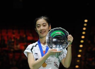 China's Wang Shixian poses with her trophy after winning the women's singles final match against Japan's Eriko Hirose in 2011's All England Open Badminton Championship at the National Indoor Arena in Birmingham, Britain, March 13, 2011. Wang won 2-0 to claim the title.