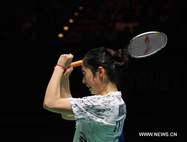 China's Wang Shixian celebrates after winning the women's singles final match against Japan's Eriko Hirose in 2011's All England Open Badminton Championship at the National Indoor Arena in Birmingham, Britain, March 13, 2011. Wang won 2-0 to claim the title.