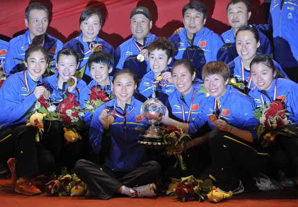 The China team poses for pictures with the Uber Cup trophy and their gold medals after defeating South Korea in the final round of Uber Cup badminton tournament in Wuhan May 26, 2012.