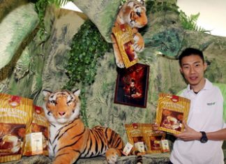 Endorsement: Lee Chong Wei posing with some of the products after signing on as the brand ambassador for CNI White Coffee Cendawan Susu Harimau and Well3 brand in Shah Alam Tuesday.