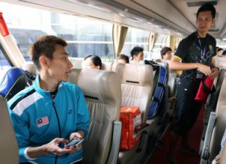 Friendly banter: Lee Chong Wei (left) having a chat with Mohd Hafiz Hashim in the team bus after their training session at the Wuhan Sports Centre Sunday.