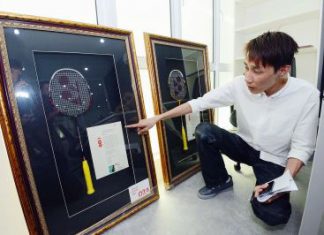 Prized possession: Chong Hoon showing the two badminton racquets that were left behind by the thieves in Chong Wei&rsquo;s office in Bandar Puteri Puchong.
