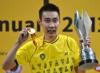 Chong Wei celebrates with his trophy and his gold medal during the awards ceremony after defeating Indonesia's Sony Dwi Kuncoro in the men's single final at the Malaysia Open Badminton Superseries in Kuala Lumpur on Jan 20
