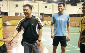 Newly-appointed national doubles coach Paulus Firman (second from left) meets up with some of the players at the training centre in Bukit Kiara yesterday.