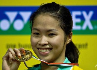 Thailand's Ratchanok Intanon displays her winning medal after beating Juliane Schenk of Germany in the women's singles final of the India Open on April 28, 2013