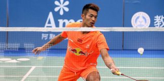 Lin Dan hits a return against Tuan Duc Do during their men's singles first round match at the Badminton Asia Championships in Taipei.