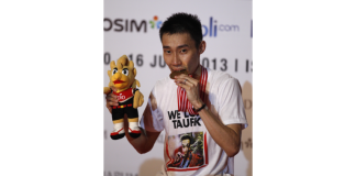 Malaysia's Lee Chong Wei bites his medal after defeating Marc Zwiebler of Germany during their final match at the Indonesia Open badminton championship at Istora stadium in Jakarta, Indonesia.