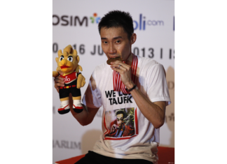 Malaysia's Lee Chong Wei bites his medal after defeating Marc Zwiebler of Germany during their final match at the Indonesia Open badminton championship at Istora stadium in Jakarta, Indonesia.