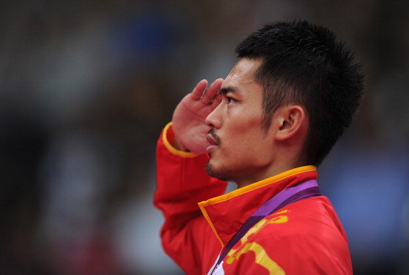 Lin Dan of China salutes on the podium after winning his Men&rsquo;s Singles Badminton Gold Medal match against Chong Wei Lee at the London 2012 Olympic Games