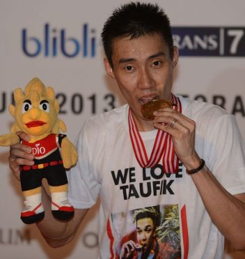 Lee Chong Wei bites his gold medal after winning the Indonesia Open title in Jakarta last month. Lee, 30, who became a father in April to son Kingston, knows that this could be his last chance to beat Lin Dan on the big stage, after losing the last two Olympic finals to the fiercely competitive Chinese player, as well as the 2011 world title match.