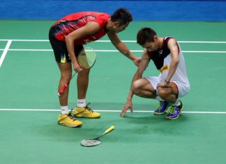 Lin Dan checks on Lee Chong Wei after the Malaysian world No.1 suffered leg cramps during their World Championships final. Lin Dan won after Chong Wei retired whilst trailing 17-20 in the third game.
