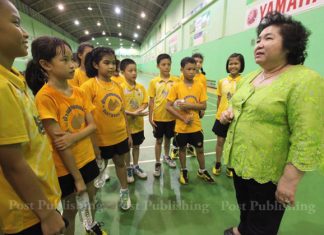 School owner Kamala Thongkorn meets with some of the aspiring badminton players.