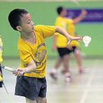 Kid learns how to serve in Intanon – May’s badminton school