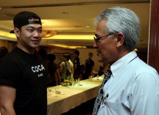The Badminton Association of Malaysia president Tengku Tan Sri Mahaleel Tengku Ariff having a word with doubles shuttler Koo Kien Keat.