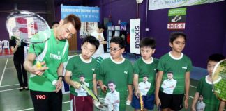 Lee Chong Wei showing the participants the proper way to hold a badminton racquet at a coaching clinic yesterday.