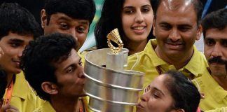 Hyderabad Hotshots player Ajay Jayaram (second from left) and Saina Nehwal (right) kissing the trophy as they celebrate after their team won the Indian Badminton League in Mumbai on Saturday.