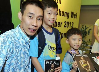 Lee Chong Wei takes a photo with young fans Lim Yu Hong, 10, and Lim Yu Ming, 7, at an autograph session at the Malaysia Sports & Health Fair 2013. He will be skipping the China Open to allow his ankle to heal but hopes to make it to the Hong Kong Open and the Super Series Finals.