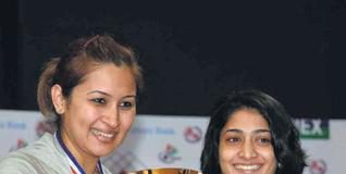 G. Jwala and Ashwini Ponnappa pose with their spoils after triumphing in straight games.