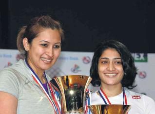 G. Jwala and Ashwini Ponnappa pose with their spoils after triumphing in straight games.