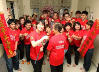 Vivian Hoo (centre) with her grandmother, 'coach' Lim Ah How, and the rest of the her family members on the eve of Chinese New Year. They are all wearing football jerseys custom-made by her uncle for the 'Home United' team.