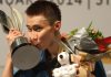 Lee Chong Wei of Malaysia kisses the trophy on the podium after winning the men's singles final match against Tommy Sugiarto of Indonesia during their Malaysia Open Badminton Superseries in Kuala Lumpur. Lee won 21-19, 21-9.