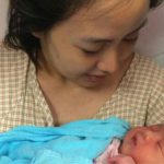 Koo Kien Keat's wife Audrey Tan Su Ven is holding their newborn son Dayson.