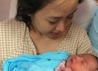 Koo Kien Keat's wife Audrey Tan Su Ven is holding their newborn son Dayson.