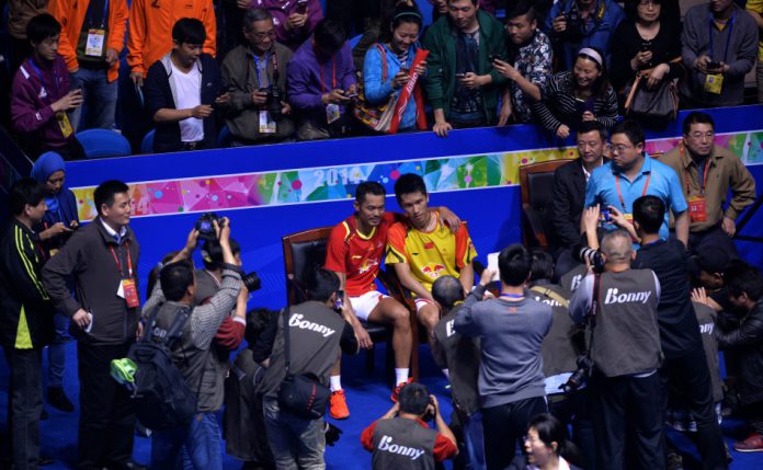 Lin Dan happily posed for pictures with Tian Houwei after the match