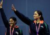 Jwala Gutta (right) and Ashwini Ponnappa wave after winning gold in the women's badminton doubles event of Commonwealth Games in New Delhi on October 14, 2010.