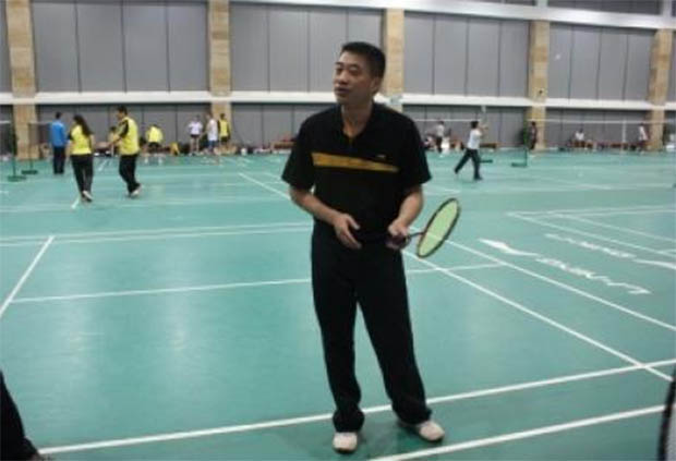 He Guoquan coaches a group of young players in China