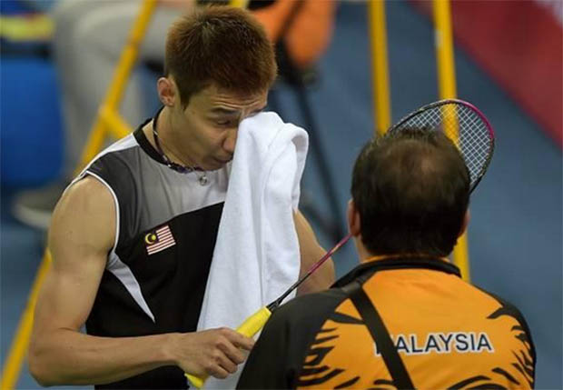 Lee Chong Wei speaks to his coach during the match