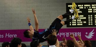 Korean shuttlers throw Lee Hyun-il up in the air after wining Asian Games men's team gold