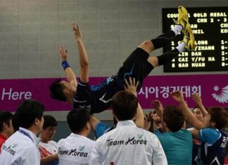 Korean shuttlers throw Lee Hyun-il up in the air after wining Asian Games men's team gold