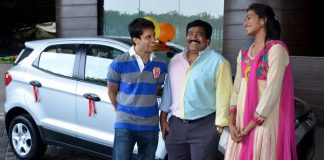 Parupalli Kashyap (left) and P. V. Sindhu standing infront of a Ford Ecosport car.