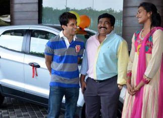 Parupalli Kashyap (left) and P. V. Sindhu standing infront of a Ford Ecosport car.