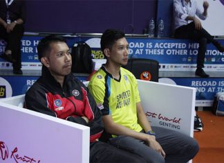 Hafiz (yellow shirt) sits next to his brother Muhammad Roslin Hashim at the Purple League