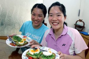 Wish Ng Hui Lin (right) and Ng Hui Ern good luck as they move onto the next stage in their life.