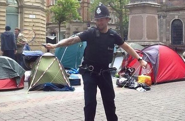 Manchester police play badminton with homeless protesters.