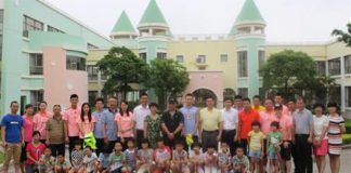 The Chinese badminton team take photos of themselves with the children.